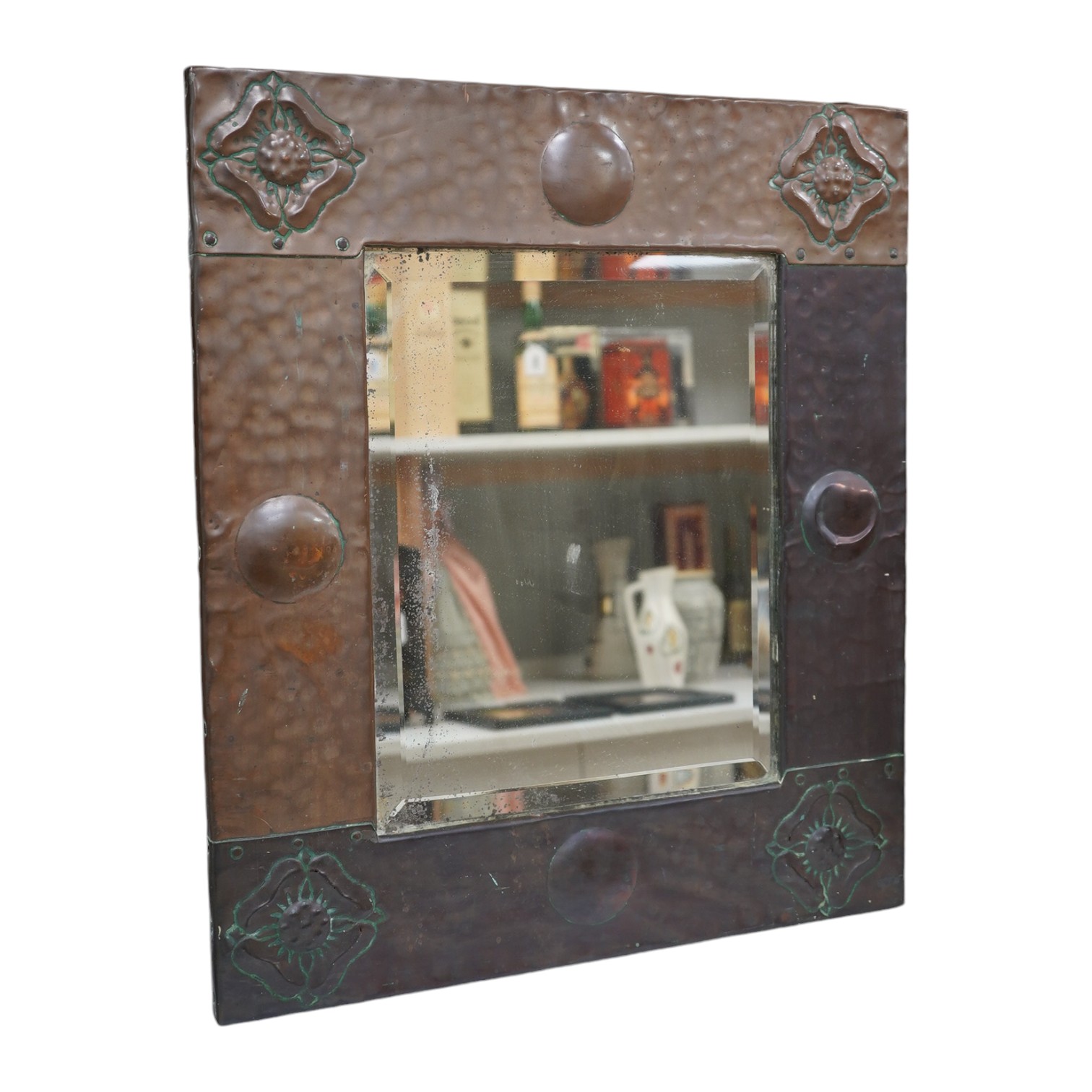 An Arts & Crafts style early 20th century copper framed mirror, 58 x 50cm. Condition - fair to good